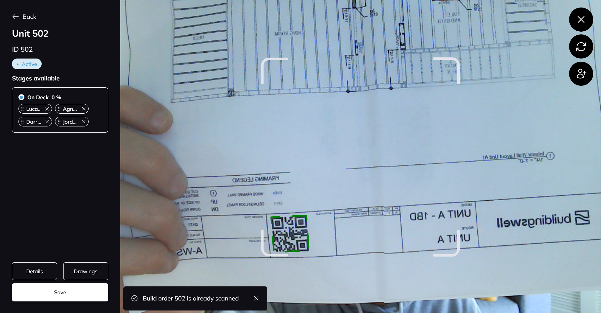 The scanner pointed at a QR code printed on a shop drawing, with the matched order, its stage and the people already scanned listed down the left.