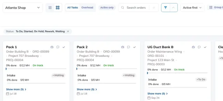 The Build page in Grid view, with each order shown as a card carrying its stages, percent done, man hours and status.